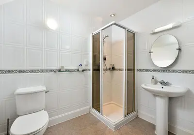 a bathroom with a shower and a toilet and a sink at The Steading at Pitmeadow Farm in Dunning