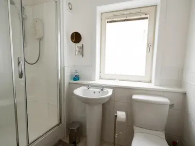 a bathroom with a toilet and a sink and a shower at Beautiful Unique 3Bed Mews Cottage House - Pass the Keys in Glasgow