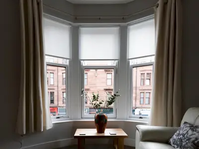 a living room with windows with a vase on a table at Superb 1Bed Flat in Fabulous West End - Pass the Keys in Glasgow
