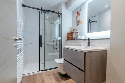 a bathroom with a shower and a toilet and a sink at Unique Two Bed Holiday Home in Edinburgh in Edinburgh