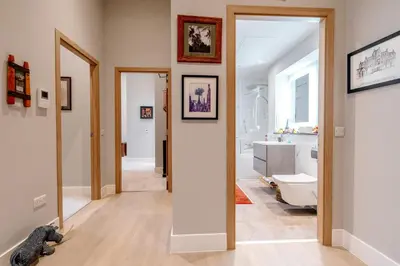 a hallway with a bathroom with a teddy bear on the floor at Unique Two Bed Holiday Home in Edinburgh in Edinburgh