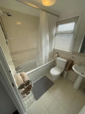 a bathroom with a tub and a toilet and a sink at 1-Bedroom Chalet at Maryville Caravan Site - Uddingston, Glasgow in Uddingston
