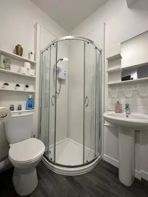 a bathroom with a shower and a toilet and a sink at One bedroom flat in Oban town centre in Oban