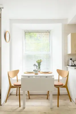 a kitchen with a white table and two chairs at Central Studio Near Usher Hall & Edinburgh Castle in Edinburgh