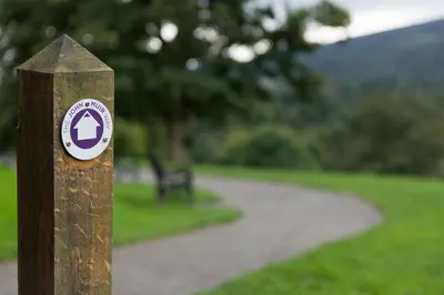 a wooden post with a sign on it in a park at Westertonhill Lodge - 4 Bedrooms Sleeps 10 with Private Hot Tub Hire Available in Balloch