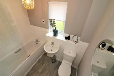 a white bathroom with a toilet and a sink at Signature - Carnbroe House in Old Monkland