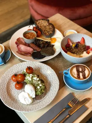 a table with plates of food and bowls of food at The Raeburn in Edinburgh