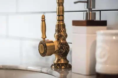 a gold faucet on a sink in a bathroom at The West End Loft - 5* Retreat - Private Parking! in Glasgow
