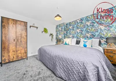 a bedroom with a large bed and a wall mural at West End House by Klass Living Bellshill in Bellshill