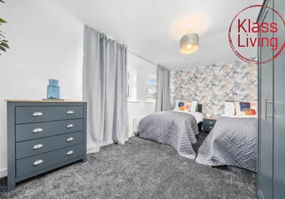 a bedroom with two twin beds and a dresser at West End House by Klass Living Bellshill in Bellshill