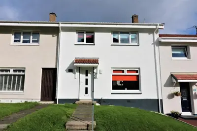 a white house with a green lawn at Signature - Sydney House in East Kilbride
