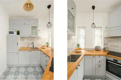 a kitchen with white cabinets and wooden counter tops at Heriot Bridge Hideaway by Calton Living in Edinburgh