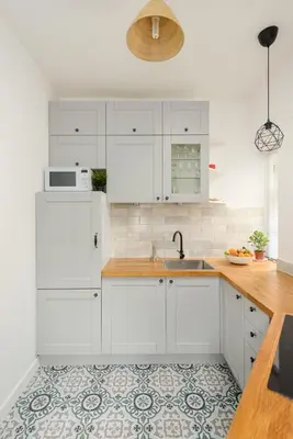 a kitchen with white cabinets and a sink at Heriot Bridge Hideaway by Calton Living in Edinburgh