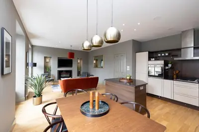 a kitchen and dining room with a table and chairs at JOIVY Stylish Flat in New Town in Edinburgh