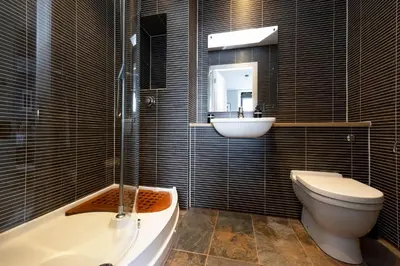 a bathroom with a tub and a sink and a toilet at JOIVY Stylish Flat in New Town in Edinburgh