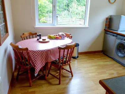 a table with a red and white checkered table cloth at Bo Nan Taigh Cottage in Aberfoyle