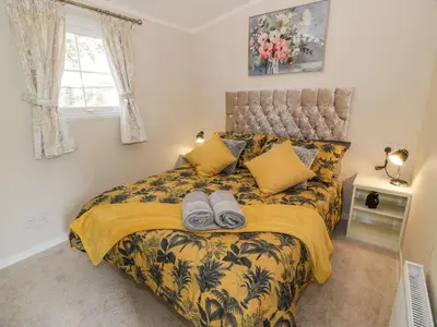 a bedroom with a bed with towels on it at 11 Mansion View in Helensburgh