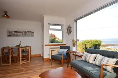 a living room with a couch and a table at Bay View in Lochgilphead