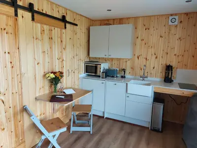 a kitchen with a counter and a table and a microwave at Callander Hostel in Callander