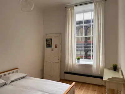 a bedroom with a bed and a window at Lovely 1-Bed Apartment in Glasgow Merchant City in Glasgow