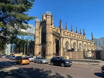 an old church with cars parked in front of it at Lovely 1-Bed Apartment in Glasgow Merchant City in Glasgow