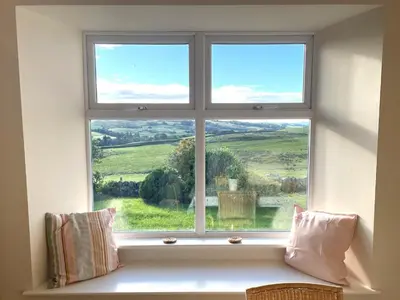 a window with a view of a green field at Beautiful 5BR Rural Cottage with Outstanding Views - Pass the Keys in Castle Douglas