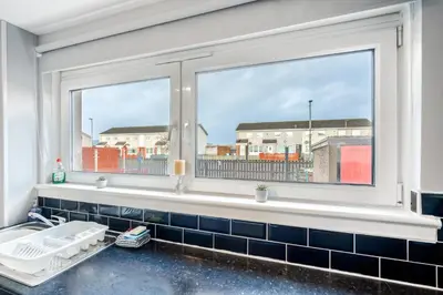 a bathroom with a window and a sink at Balloch House -Spacious 3 bed house with on street parking in Kirk of Shotts