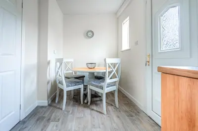a small dining room with a table and chairs at Millfield House - Cosy 2 bed house in Motherwell in Motherwell