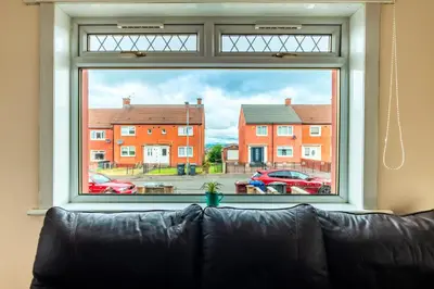 a large window with a couch in front of it at Scotia House -3 bed house in Larkhall with private driveway in Larkhall