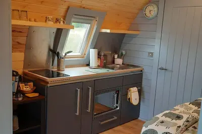 a small kitchen with a sink and a stove at Dalrigh Pod in Onich