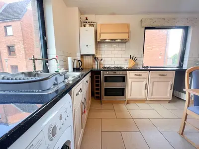 a kitchen with a sink and a stove at Anniesland Glasgow 1bd Flat - Free Parking in Glasgow