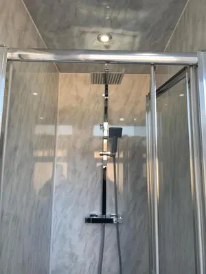 a shower with a glass door in a bathroom at Ibrox Argyll Inn in Glasgow
