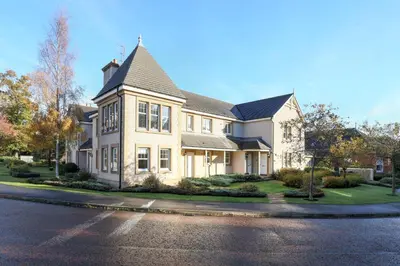 a large white house with a black roof at JOIVY Modern Flat with Free Parking in Edinburgh