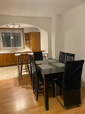 a dining room with a black table and chairs at 3 bedroom home-inverkeithing in Fife