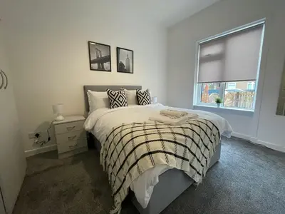 a bedroom with a bed and a window at Cardonald House in Glasgow