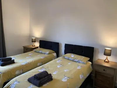 a bedroom with two beds and two night stands at Svarga Mountain View in Kinlochleven