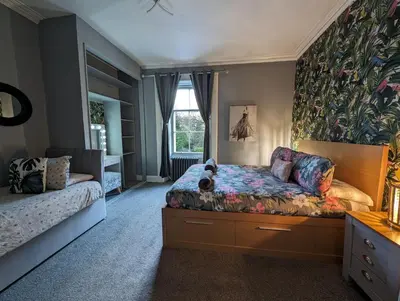 a bedroom with a bed and a window at Bonnyside House in Bonnybridge
