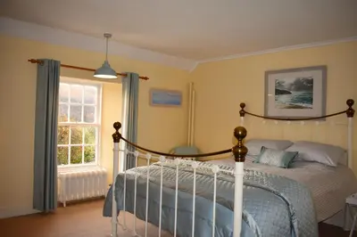 a bedroom with a bed and a window at Creran Apartment, Kinlochlaich House in Appin