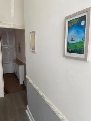 a hallway with a white wall with a picture on it at The Princess Flat, Helensburgh. in Helensburgh