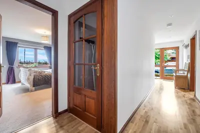 a door leading to a bedroom with a view of the ocean at The Keep at Craigiehall in Edinburgh
