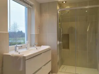 a bathroom with a sink and a glass shower at Whitehouse Studio in Roslin