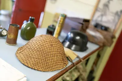 a straw hat sitting on a counter in a kitchen at Cultybraggan Hut 37 in Comrie