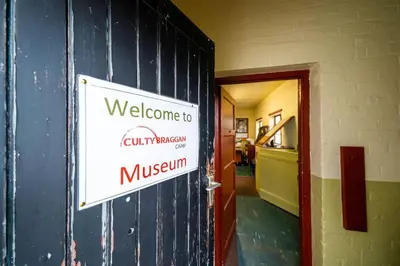 a welcome sign on the wall of a building at Cultybraggan Hut 35 in Comrie