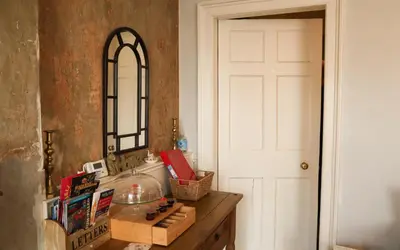 a room with a table with a mirror and a door at 1 Bedrooms Flat in Central Edinburgh Haymarket, Heart of Edinburgh Flat Sleeps 4 , in Edinburgh