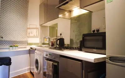a kitchen with a microwave and a stove top oven at 1 Bedrooms Flat in Central Edinburgh Haymarket, Heart of Edinburgh Flat Sleeps 4 , in Edinburgh