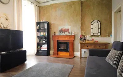a living room with a fireplace and a tv at 1 Bedrooms Flat in Central Edinburgh Haymarket, Heart of Edinburgh Flat Sleeps 4 , in Edinburgh