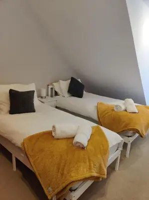 two beds with towels on them in a room at West End & EICC with Parking in Edinburgh