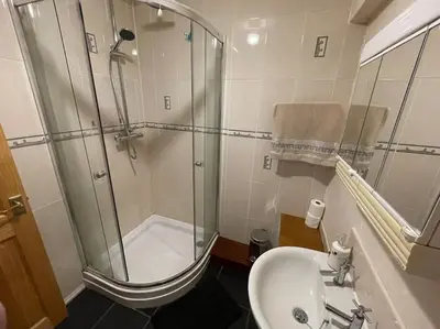 a bathroom with a shower and a sink at West End Hidden Gem - Modern 2-Bedroom Apartment with residents patio in Anniesland