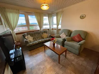 a living room with a couch and a coffee table at West End Hidden Gem - Modern 2-Bedroom Apartment with residents patio in Anniesland