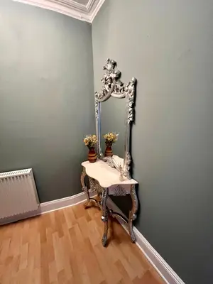 a dressing table with a mirror on a wall at Anchorage, a lovely 2nd floor one bedroom apartment with fabulous seaviews in Largs